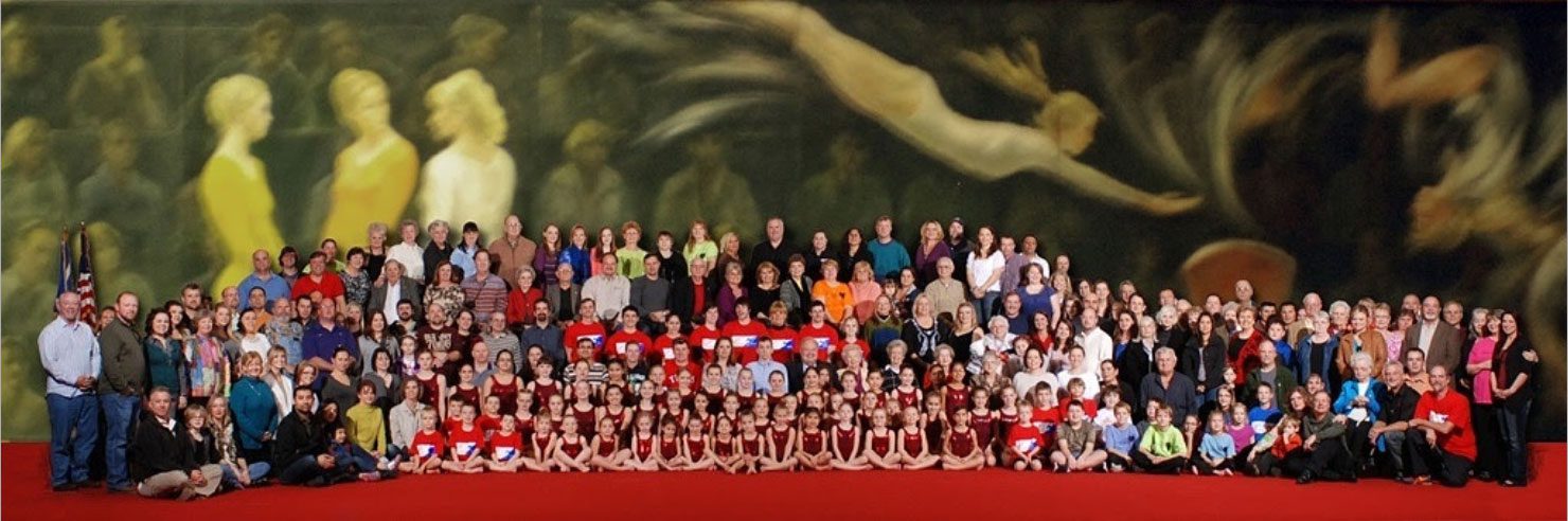 A group of people that are standing up in front of a wall.